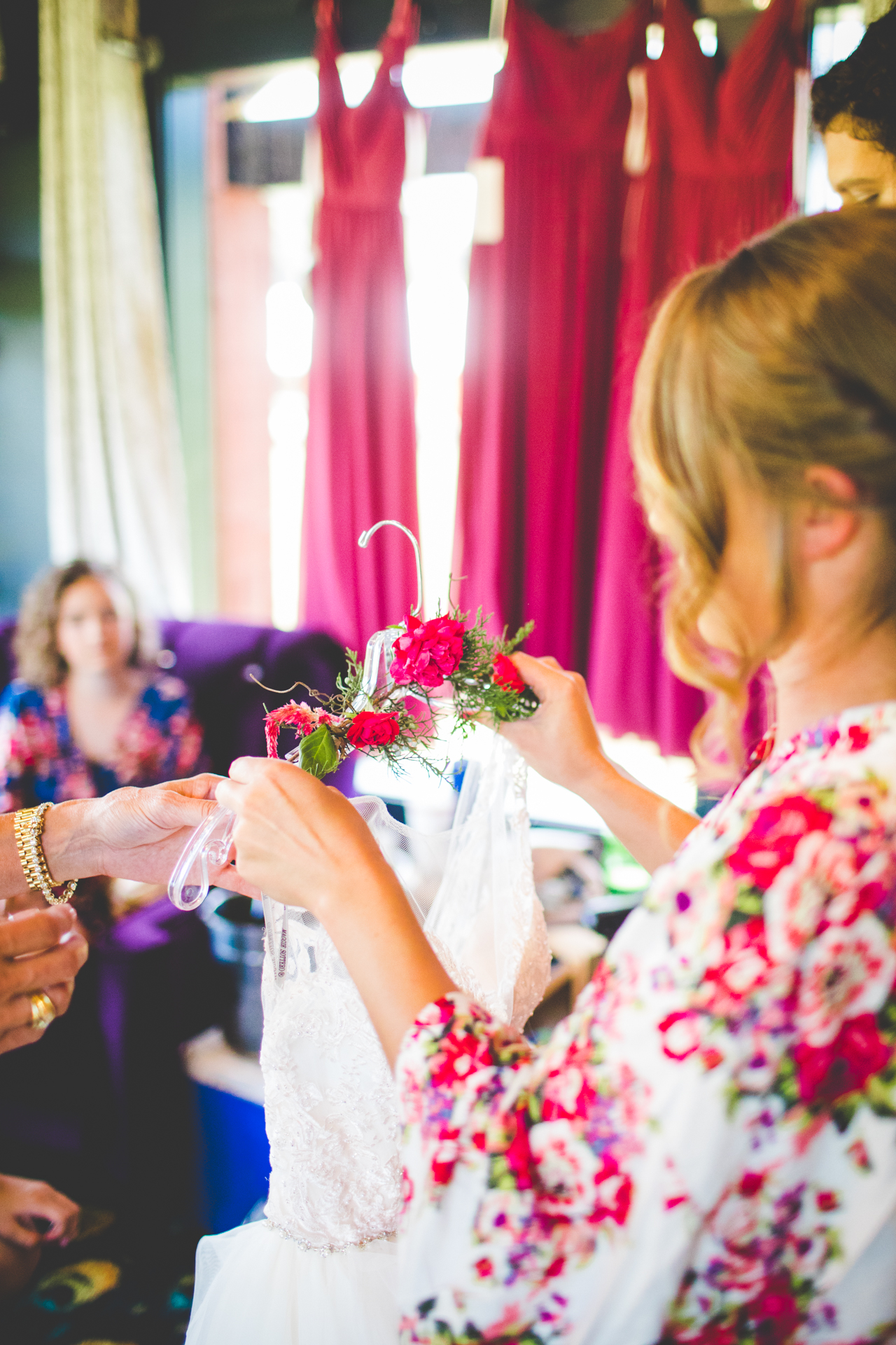 detail photograph of bride getting ready, flowers on wedding dress hanger, lissa chandler photography 