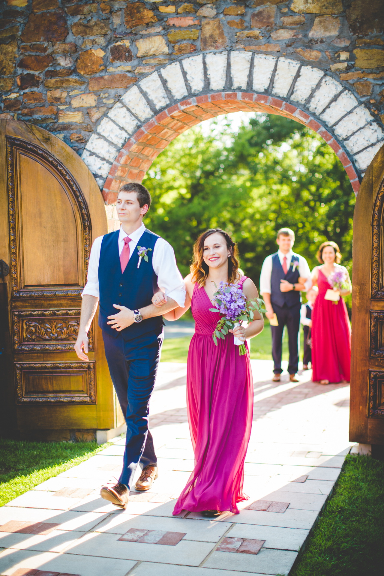 Bridesmaid and Groomsmen walk down aisle at Sassafras Springs