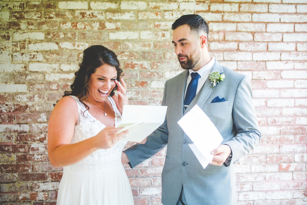 bride and groom read letters on wedding day, happy wedding photos in Fayetteville AR