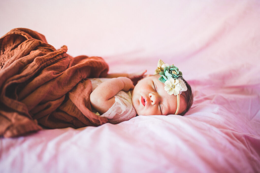 newborn photographs on pink backdrop