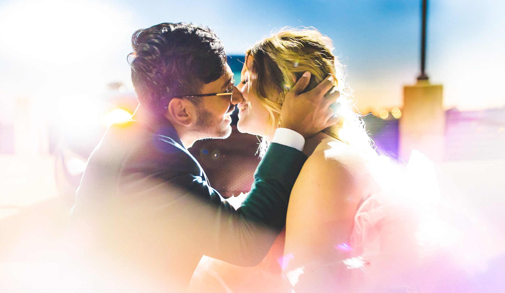 bride and groom kiss in headlights, colorful and whimsical wedding photography by Lissa Chandler
