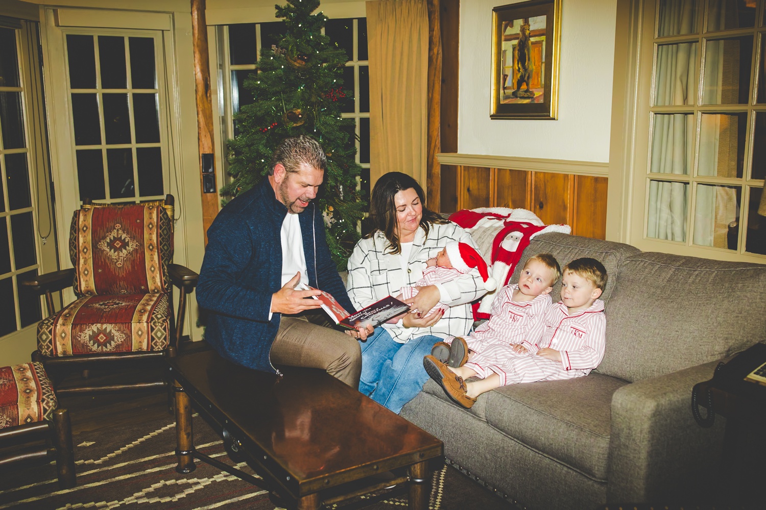 Grandparents Reading Books to Kids By Christmas Tree