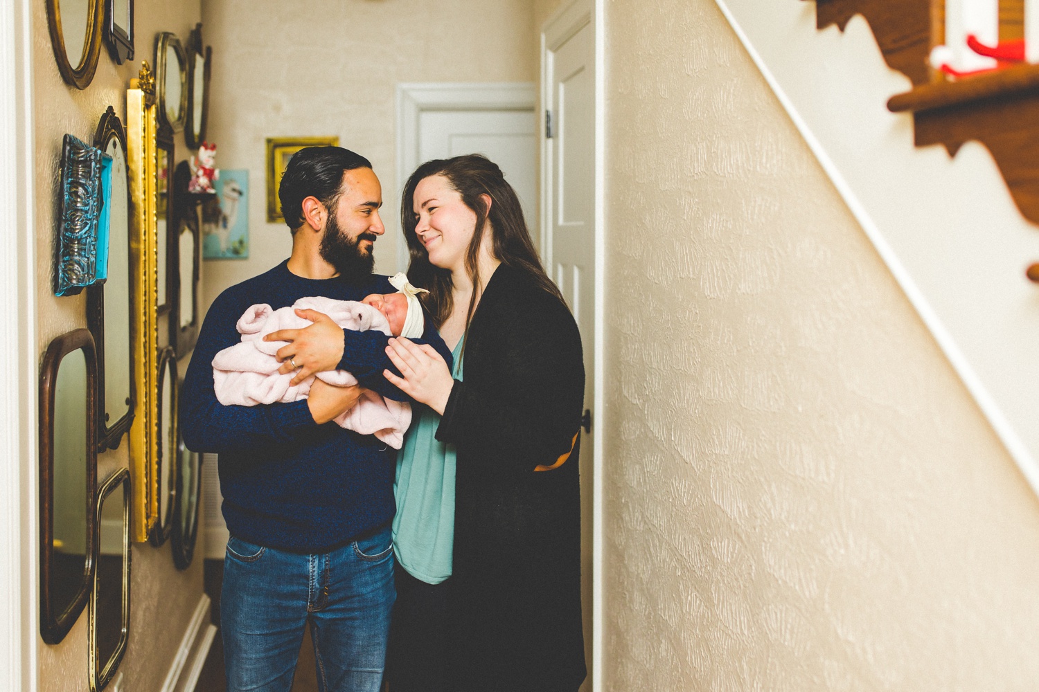 newborn family photographs taken in hallway 