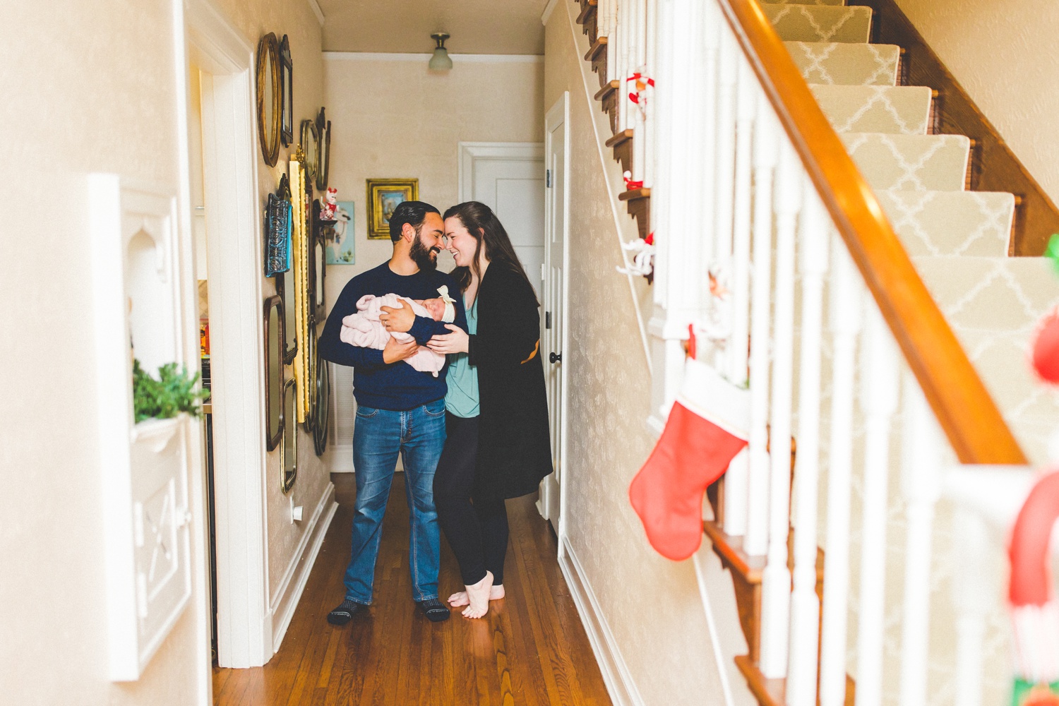 newborn family photographs taken in hallway 