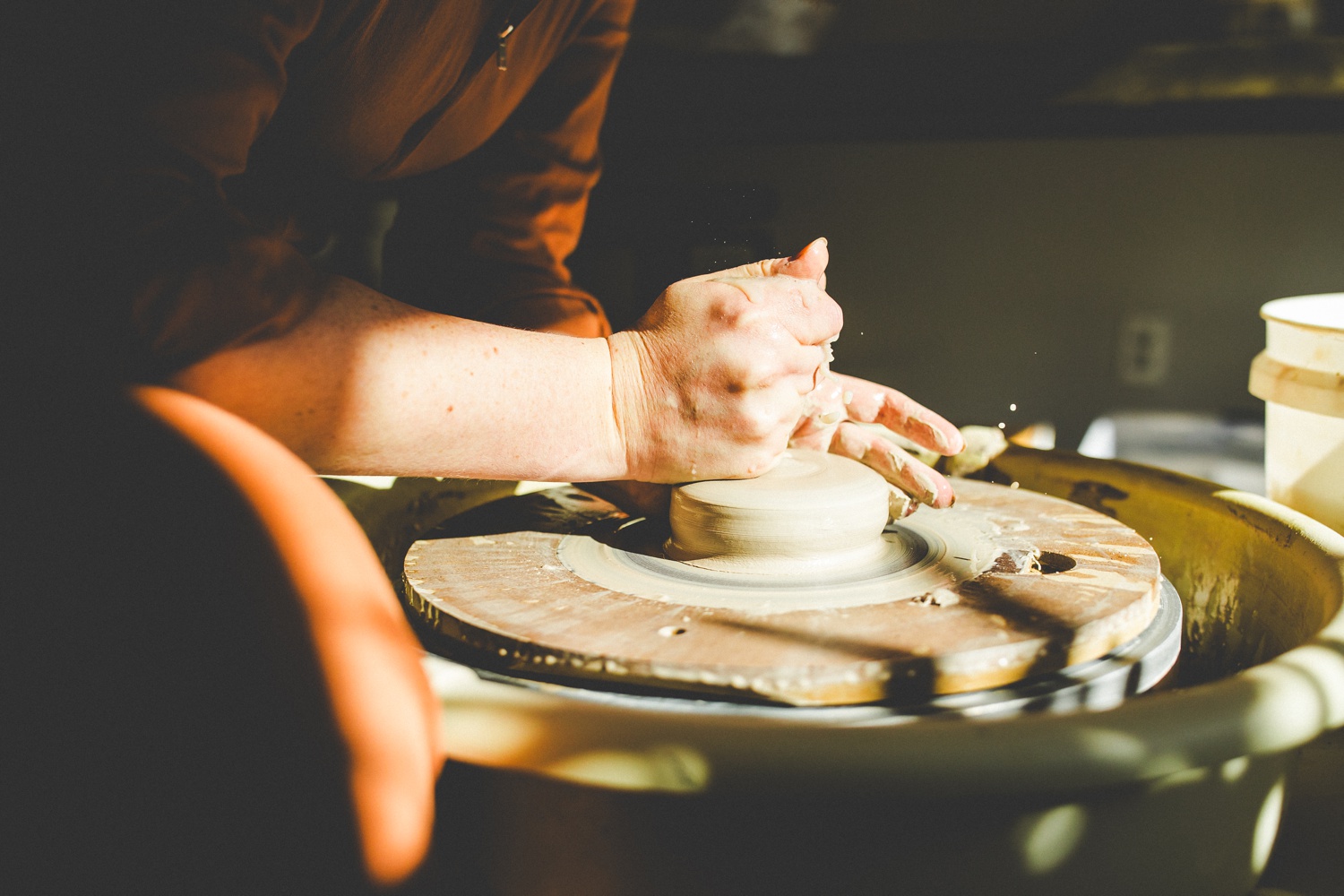 close up of potter's hands at wheel