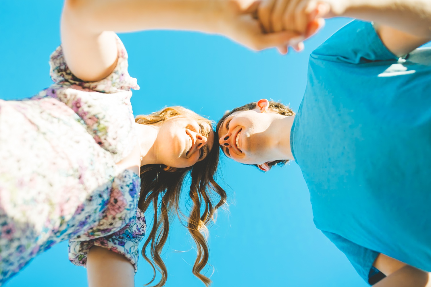 Unique Engagement Photographs with Blue Sky