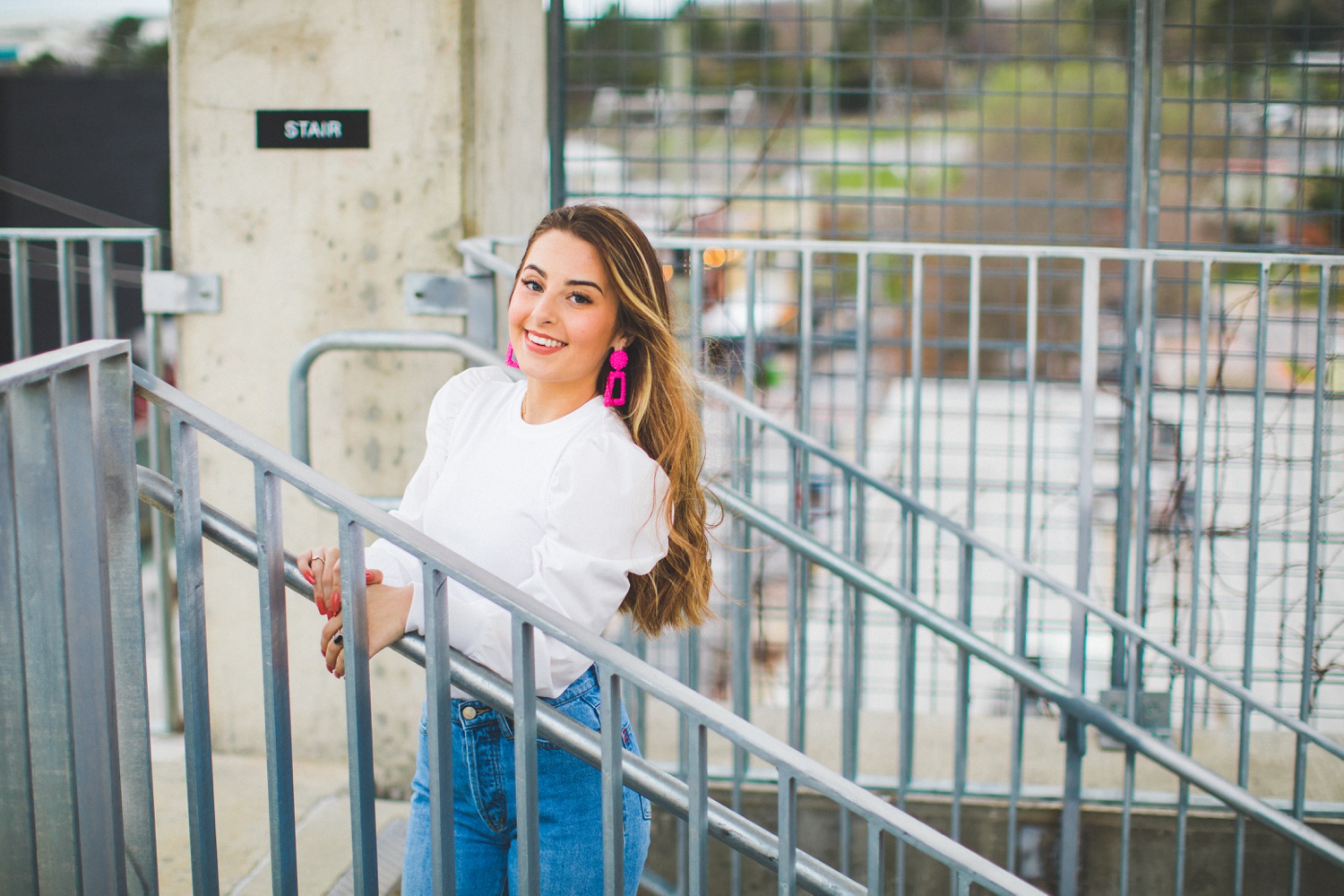 cute senior pictures in parking garage with 90s vibe