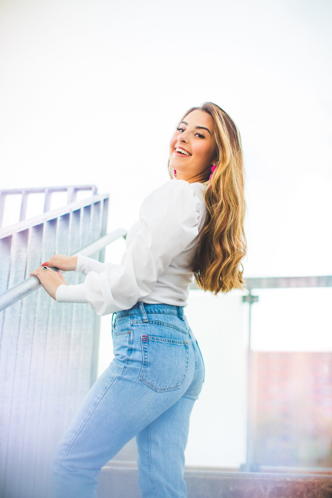 cute senior pictures in parking garage with 90s vibe