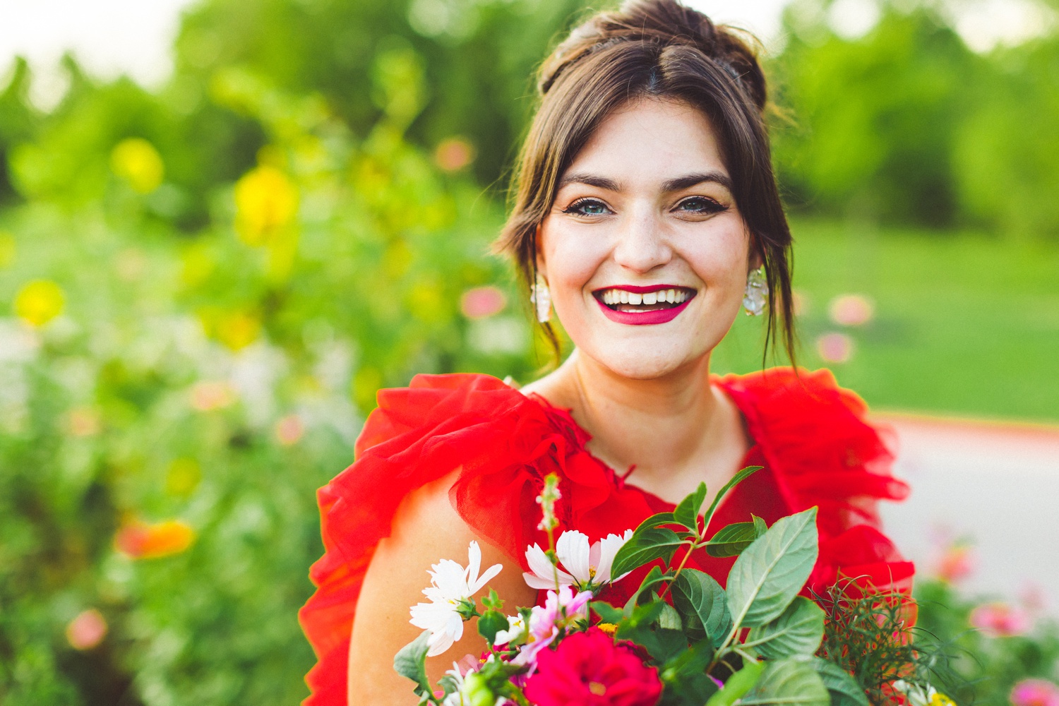 red wedding dress in garden wedding setting 