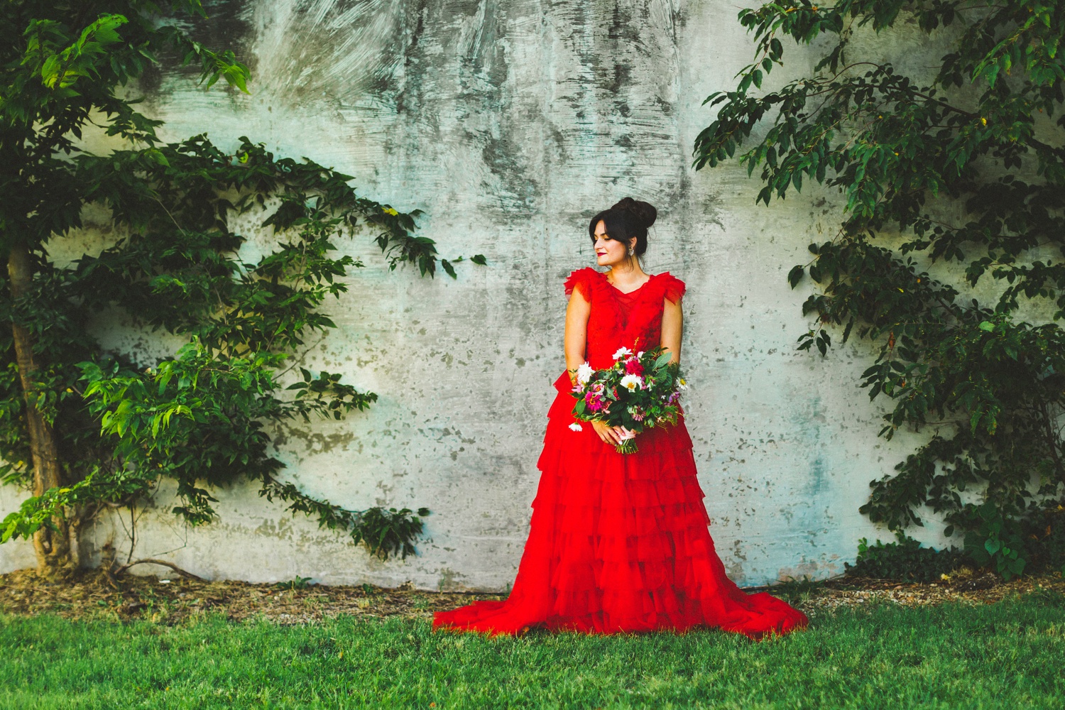 red wedding dress in garden wedding setting 